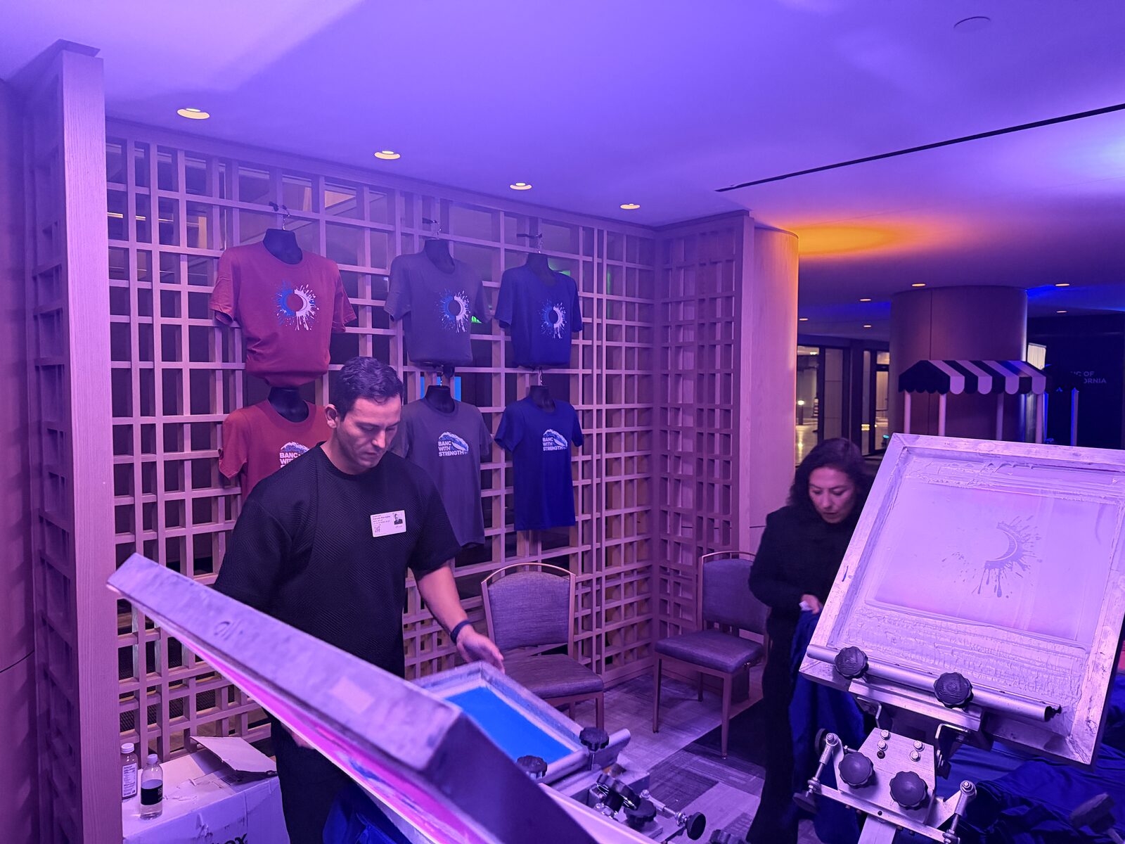 Wall of finished event shirts printed on site